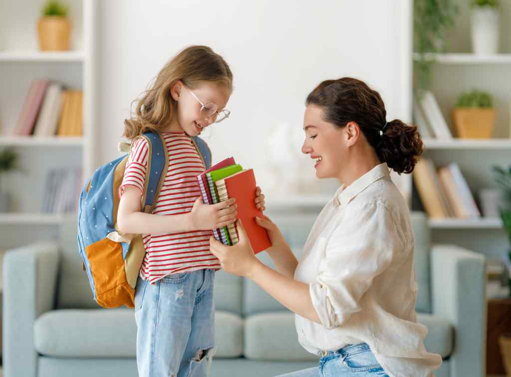 Happy parent and daughter preparing for school.