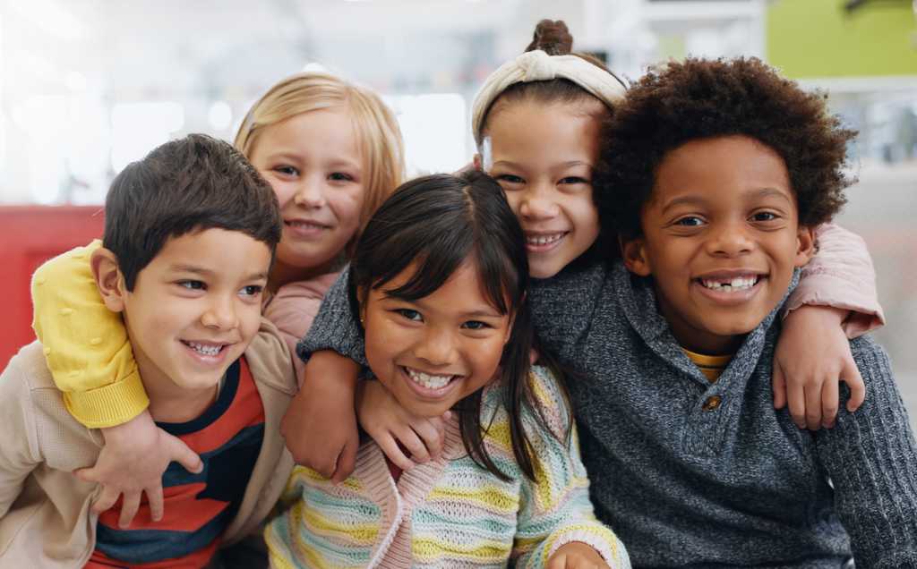 Group of smiling kids being happy at school